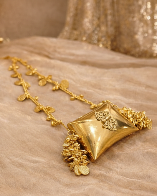 Gold and silver jewelry pieces on a textured surface