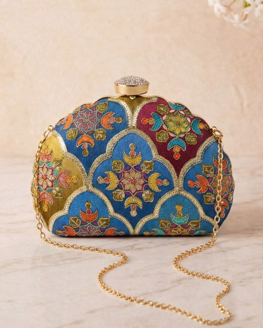 Decorative clutch bag with intricate patterns on a light background