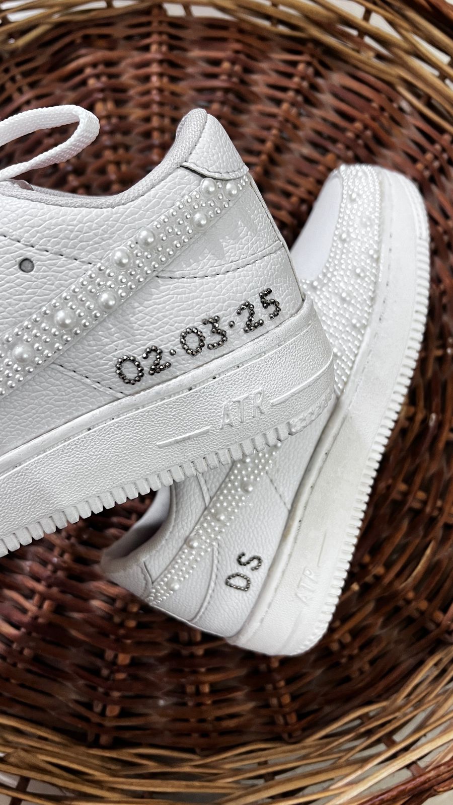 White sneakers with text on a woven surface