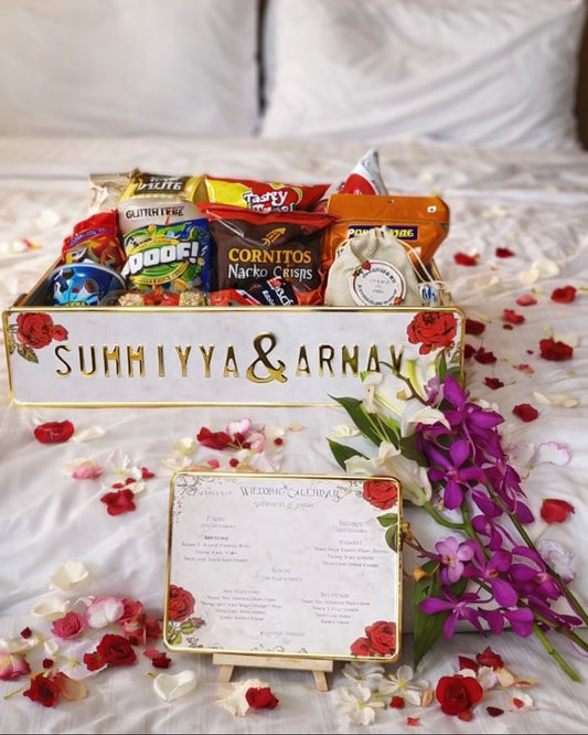 Elegant Personalized Wedding Welcome Setup with Floral Styling on Luxury Hotel Bed